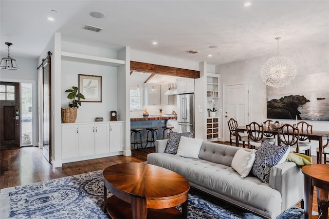 4801 Balcones Dr, Austin, TX 78731 - living area with dark wood-style flooring, a chandelier, a barn door, and recessed lighting