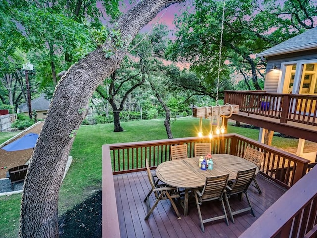 4801 Balcones Dr, Austin, TX 78731 - deck at dusk with outdoor dining area and a lawn