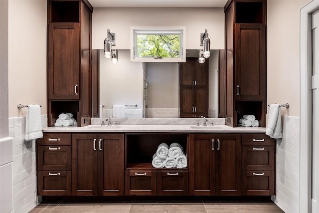 4801 Balcones Dr, Austin, TX 78731 - bathroom featuring double vanity, wainscoting, and tile walls