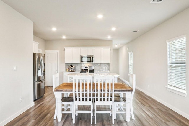 1208 Tipton St, Georgetown, TX 78633 - dining room featuring wood finished floors, baseboards, and recessed lighting