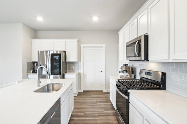1208 Tipton St, Georgetown, TX 78633 - kitchen featuring stainless steel appliances, a sink, wood finished floors, light countertops, and tasteful backsplash
