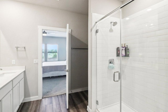 1208 Tipton St, Georgetown, TX 78633 - ensuite bathroom featuring wood finished floors, a shower stall, vanity, and baseboards