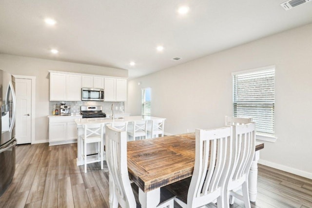 1208 Tipton St, Georgetown, TX 78633 - dining area featuring healthy amount of natural light, light wood finished floors, recessed lighting, and baseboards