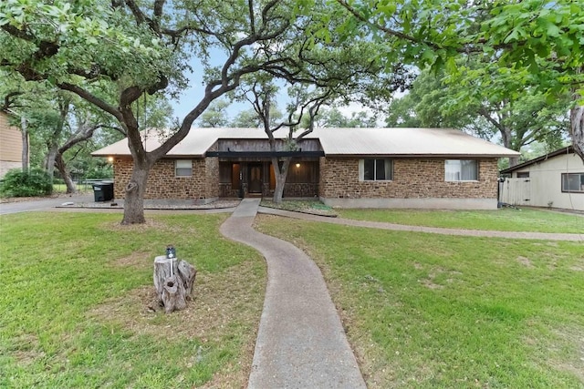 1402 Brown St, San Marcos, TX 78666 - single story home featuring brick siding and a front yard