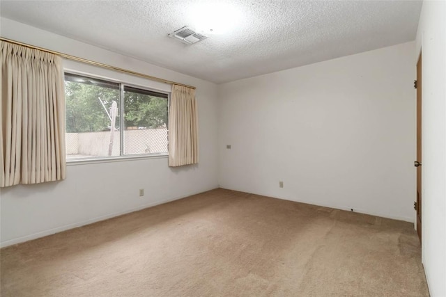1402 Brown St, San Marcos, TX 78666 - spare room featuring carpet floors, a textured ceiling, and visible vents