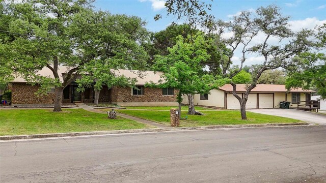 1402 Brown St, San Marcos, TX 78666 - ranch-style home featuring an attached garage, driveway, and a front yard
