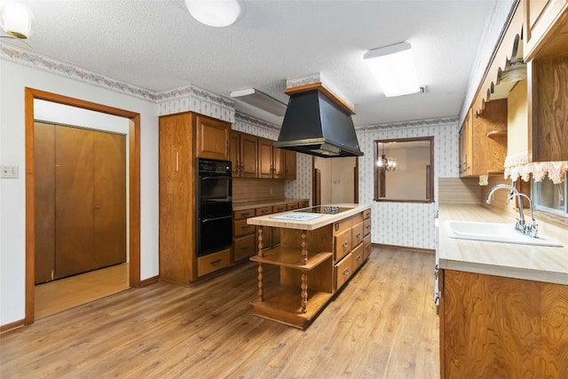 1402 Brown St, San Marcos, TX 78666 - kitchen with open shelves, wallpapered walls, light countertops, a sink, and black appliances