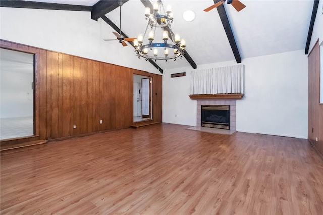 1402 Brown St, San Marcos, TX 78666 - unfurnished living room with high vaulted ceiling, a tiled fireplace, beam ceiling, and ceiling fan with notable chandelier