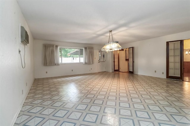 1402 Brown St, San Marcos, TX 78666 - empty room with baseboards, an inviting chandelier, and a wall unit AC