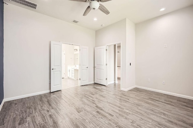 unfurnished bedroom featuring visible vents, baseboards, and wood finished floors