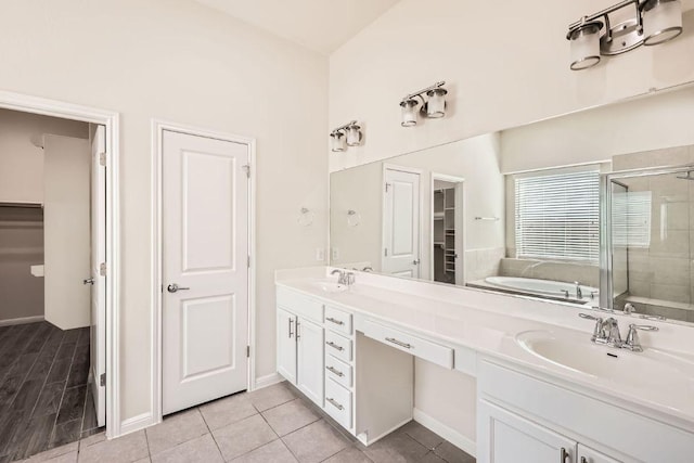 full bathroom with tile patterned flooring, double vanity, a bath, a shower stall, and a sink