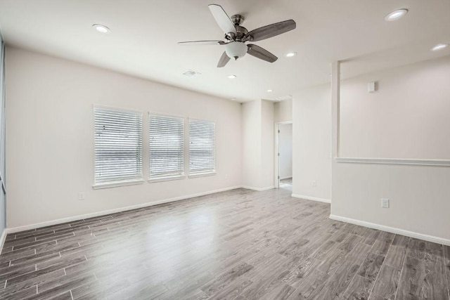 empty room featuring recessed lighting, a ceiling fan, baseboards, and wood finished floors