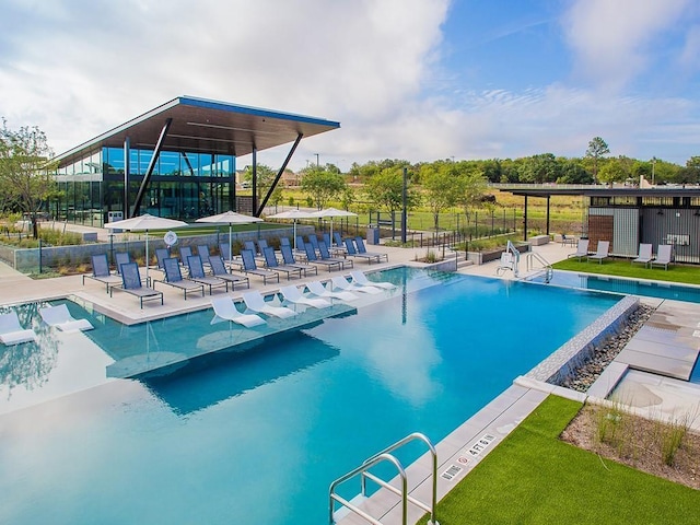 community pool with a patio and fence