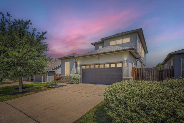7808 Glover Dr, Austin, TX 78744 - view of front of house with stucco siding, a garage, and driveway