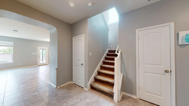 387 Gustaf Trl, Kyle, TX 78640 - stairs featuring arched walkways and tile patterned flooring