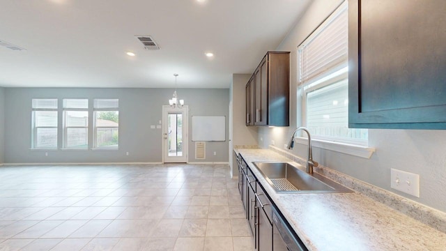 387 Gustaf Trl, Kyle, TX 78640 - kitchen with light countertops, light tile patterned flooring, a chandelier, recessed lighting, and pendant lighting