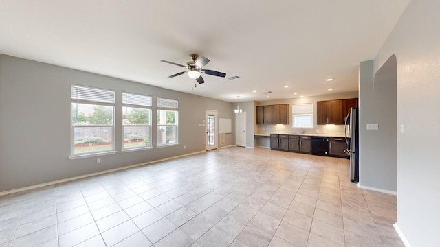 387 Gustaf Trl, Kyle, TX 78640 - unfurnished living room featuring healthy amount of natural light, ceiling fan, recessed lighting, and light tile patterned floors