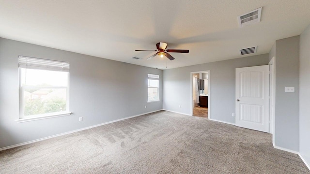 387 Gustaf Trl, Kyle, TX 78640 - unfurnished bedroom featuring carpet floors, connected bathroom, and ceiling fan
