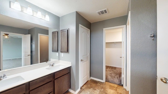 387 Gustaf Trl, Kyle, TX 78640 - full bathroom featuring double vanity, a walk in closet, and ceiling fan