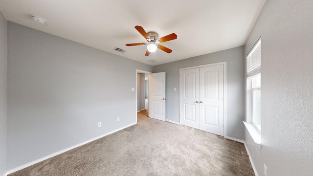 387 Gustaf Trl, Kyle, TX 78640 - unfurnished bedroom featuring carpet floors, a closet, and a ceiling fan