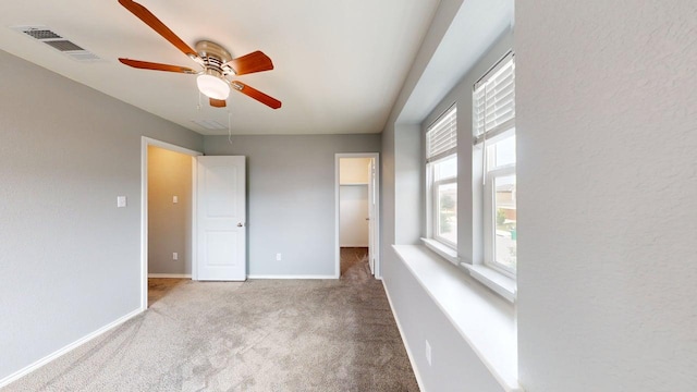387 Gustaf Trl, Kyle, TX 78640 - unfurnished bedroom featuring carpet floors, a walk in closet, attic access, and ceiling fan