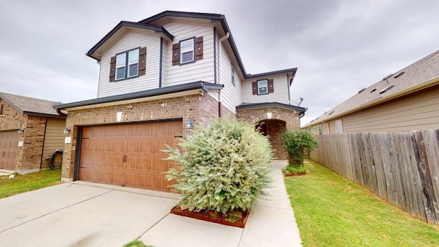 387 Gustaf Trl, Kyle, TX 78640 - traditional home featuring an attached garage, brick siding, and driveway