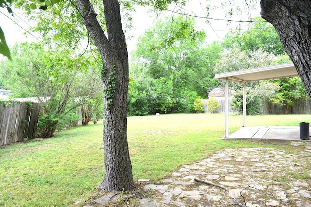 view of yard with fence and a patio