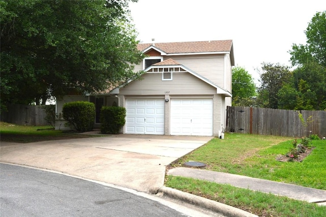 view of front facade featuring concrete driveway, an attached garage, fence, and a front yard
