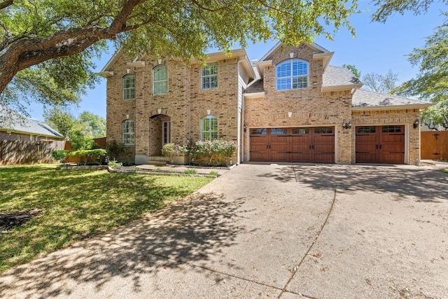 3109 Brigham Ct, Austin, TX 78732 - traditional home with brick siding, fence, driveway, and a front yard