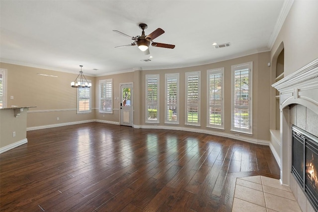 3109 Brigham Ct, Austin, TX 78732 - unfurnished living room with visible vents, crown molding, a fireplace, wood finished floors, and ceiling fan with notable chandelier