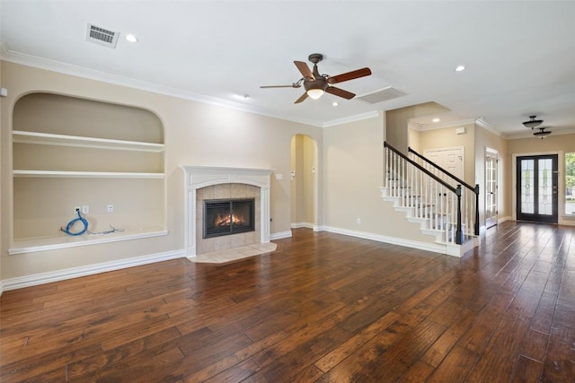 3109 Brigham Ct, Austin, TX 78732 - unfurnished living room featuring wood-type flooring, visible vents, stairway, and a tile fireplace
