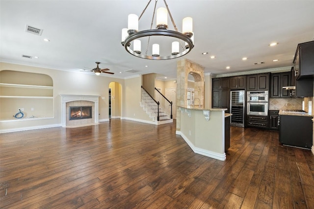 3109 Brigham Ct, Austin, TX 78732 - kitchen with visible vents, recessed lighting, ceiling fan with notable chandelier, and double oven
