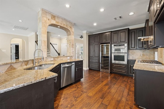 3109 Brigham Ct, Austin, TX 78732 - kitchen featuring visible vents, a sink, appliances with stainless steel finishes, and beverage cooler