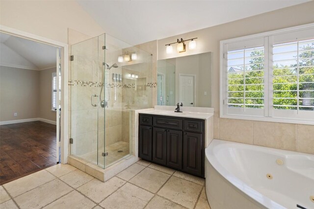 3109 Brigham Ct, Austin, TX 78732 - bathroom featuring vaulted ceiling, a whirlpool tub, a shower stall, and vanity