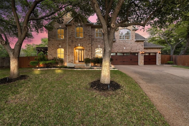 3109 Brigham Ct, Austin, TX 78732 - view of front facade featuring a lawn, fence, driveway, and brick siding