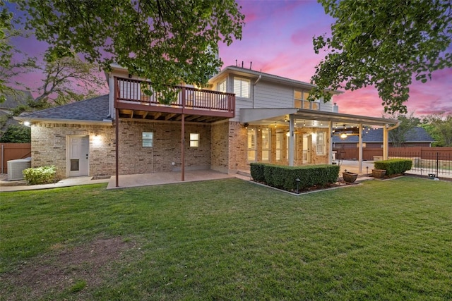 3109 Brigham Ct, Austin, TX 78732 - back of house at dusk with a patio area, brick siding, and a wooden deck