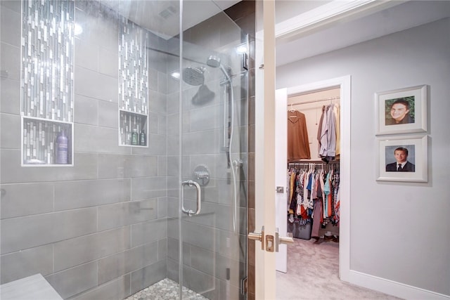 4411 Bilboa Dr, Austin, TX 78759 - bathroom with a stall shower, a spacious closet, and baseboards