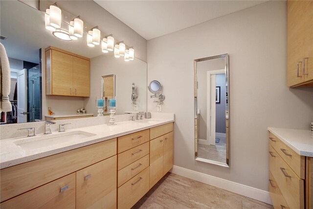 4411 Bilboa Dr, Austin, TX 78759 - bathroom featuring double vanity and baseboards