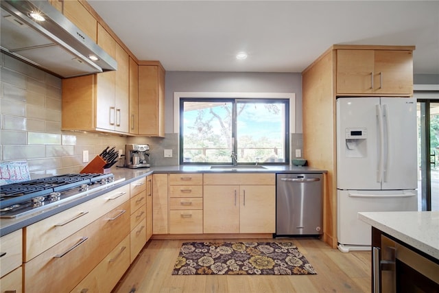 4411 Bilboa Dr, Austin, TX 78759 - kitchen with appliances with stainless steel finishes, light brown cabinetry, under cabinet range hood, a sink, and light wood-style floors