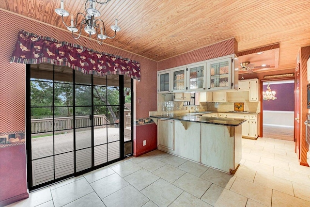 kitchen with light tile patterned flooring, dark countertops, a peninsula, wooden ceiling, and glass insert cabinets