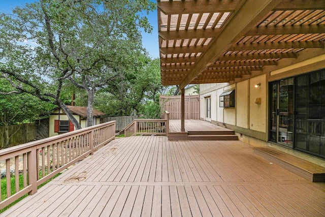 wooden deck featuring a fenced backyard and a pergola