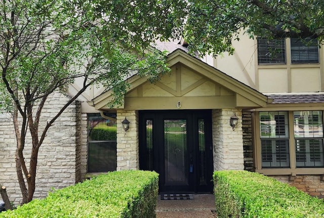 property entrance with stone siding