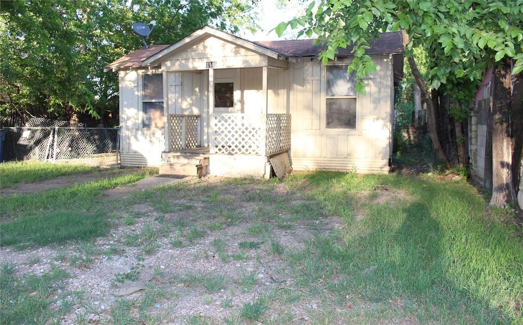 bungalow-style house with fence and roof with shingles