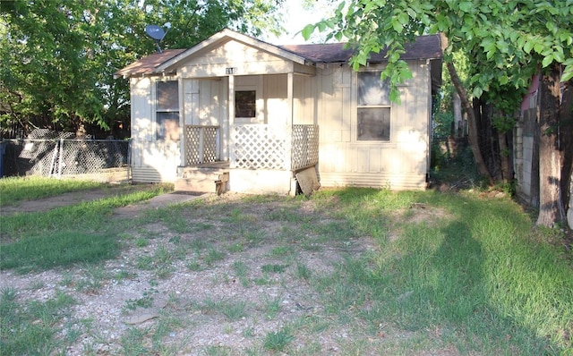 bungalow-style house with fence and roof with shingles