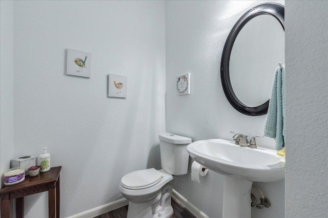 1500 Mexican Heather Ct, Pflugerville, TX 78660 - bathroom with wood finished floors, toilet, and baseboards