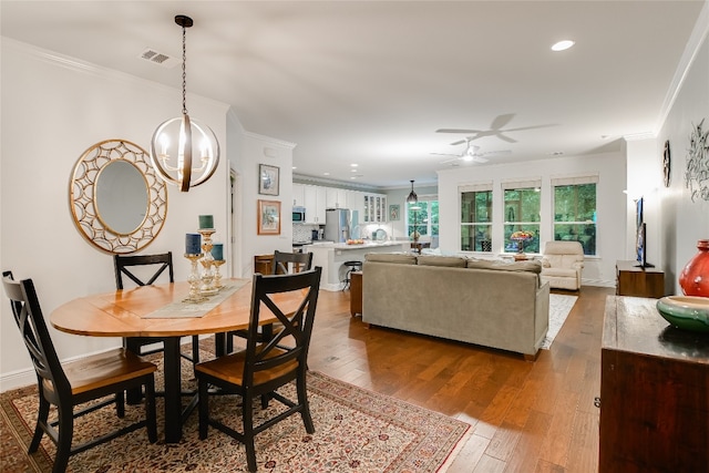 712 Independence Creek Ln, Georgetown, TX 78633 - dining room with ornamental molding, ceiling fan with notable chandelier, and visible vents