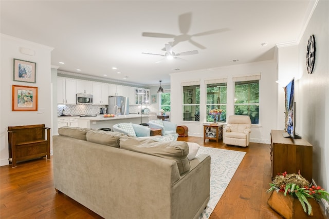 712 Independence Creek Ln, Georgetown, TX 78633 - living area with crown molding, ceiling fan, and dark wood-type flooring