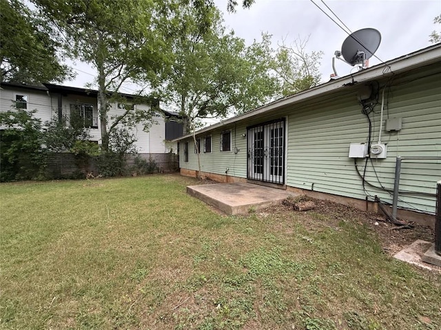 back of house with a lawn, fence, a patio area, and french doors