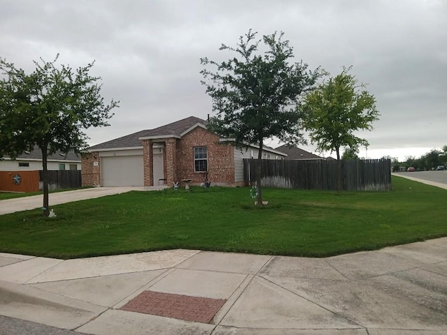 single story home with brick siding, a front lawn, fence, and concrete driveway