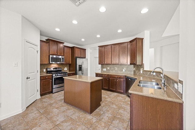 kitchen with a kitchen island, recessed lighting, tasteful backsplash, a sink, and appliances with stainless steel finishes